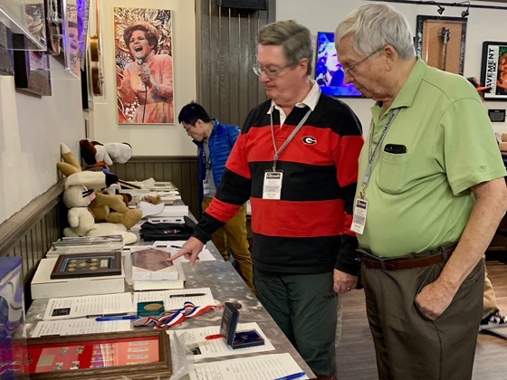 Scott & Don Bigsby inspecting the silent auction offerings.